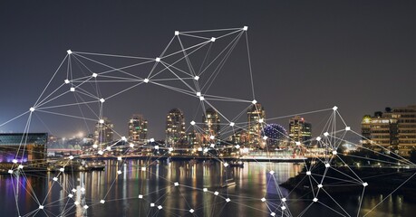 Composition of net of connections over a cityscape in background