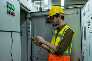 Electrical engineer checking status switchgear electrical energy distribution substation in factory.