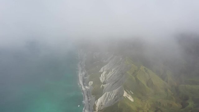 White cliffs of Iturup through the clouds