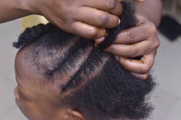 Making new hair style for an African girl child 
