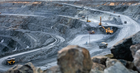 Work of heavy equipment in an open pit for gold ore mining - obrazy, fototapety, plakaty