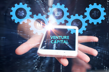 Business, Technology, Internet and network concept. Young businessman working on a virtual screen of the future and sees the inscription: Venture capital