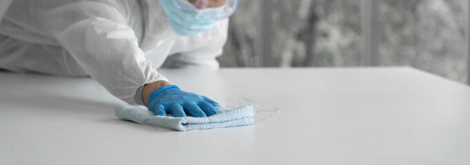 Man in virus protective suite and mask cleaning covid19 infected area, Virus disinfection concept