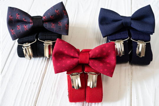 Composition of business accessories for men in vintage style - bow tie, suspenders, handkerchief and cufflinks.