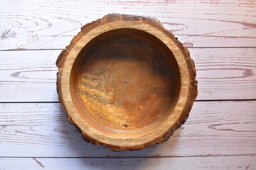 Brown empty round wooden bowl made from teak wood