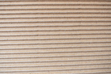 Brown color corrugated cardboard box textured background with horizontal ridges