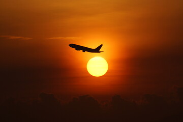 Sun and the aero plane rising on the dawn sky