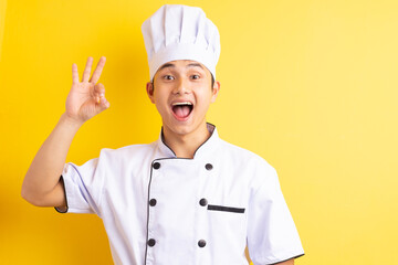 Image of Asian male chef on yellow background