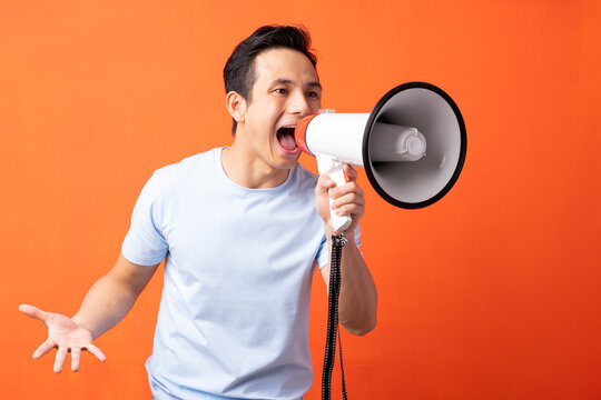 Asian Man Holding Megaphone And Shouting