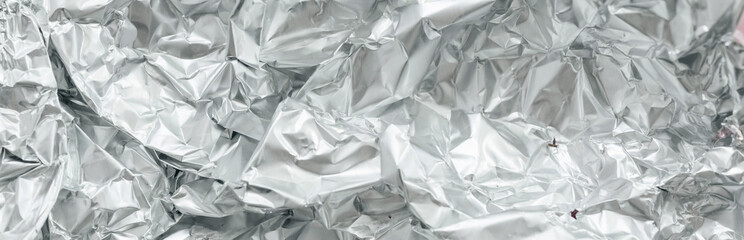 Silver crumpled foil banner background. Silver Texture, Silver Gradient background, Shiny and metal steel gradient.