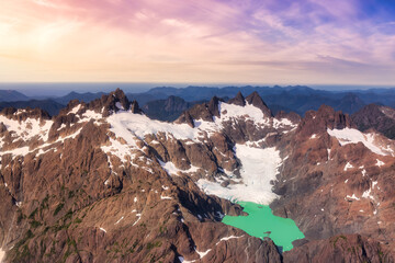 Aerial View of Canadian Rocky Mountains Landscape with Glacier Lake. Artistic Render. Sunset Sky. Woss Lake Provincial Park, Vancouver Island, British Columbia, Canada. Nature Background