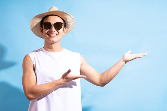Portrait of handsome asian man wearing sunglasses, Summer vacation concept