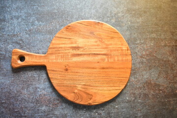 Round empty wooden chopping board made from acacia wood