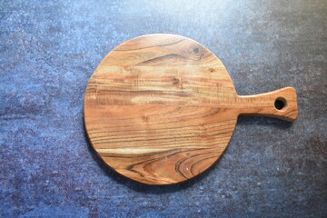 Round empty wooden chopping board made from acacia wood