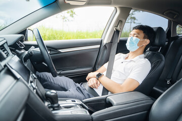 Asian businessman driving car sleeping take rest wearing protective surgical face mask protection covid-19 coronavirus pandemic safety commuter traveling work business travel social distancing