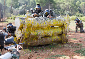 daring teams facing on battlefield in outdoor paintball arena during the match