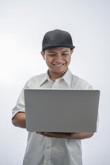 portrait of a cheerful teenager holding a laptop computer  isolated in white