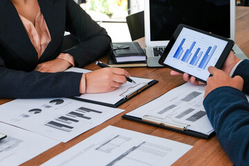 Businessman holding in hand tablet. hand pointing screen presented in tablet. discussing new project presentation Serious professional advisor consulting in office