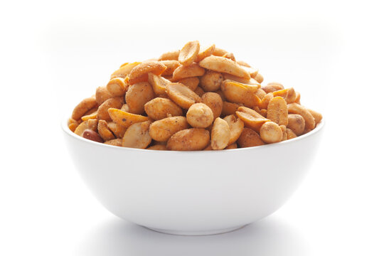 Close up of Crunchy masala peanuts Indian namkeen (snacks) on a ceramic white bowl