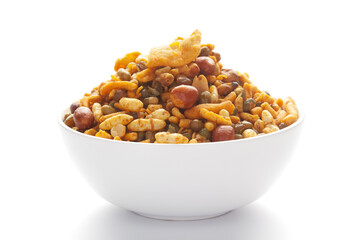 Close up of spicy Ratlami mixture Indian namkeen (snacks) on a ceramic white bowl.