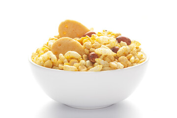 Close up of Bhel puri Indian namkeen (snacks) on a ceramic white bowl.