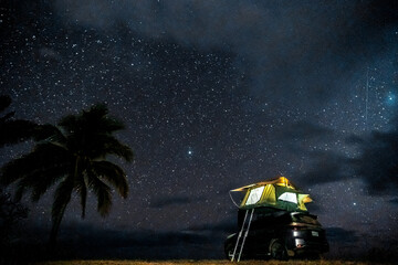 Car with roof top tent under a starry sky, overland