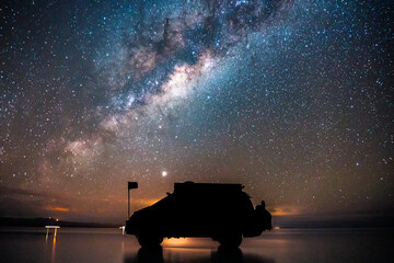 Milky way in the Salar of Uyuni, car silhouette