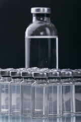 Glass medical ampoule vial for injection. Medicine is dry white drug penicillin powder or liquid with of aqueous solution in ampulla. Close up.