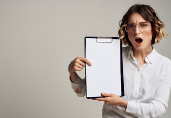 Woman with a white sheet of paper in a folder with short hair Copy Space