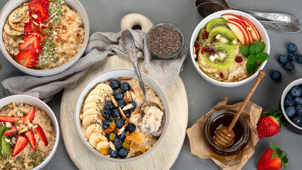 Oatmeal bowls with delicious fruits and fresh berries on light background.