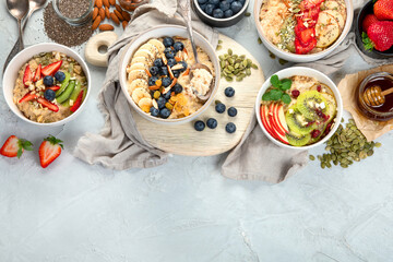 Oatmeal bowls with delicious fruits and fresh berries on light background.