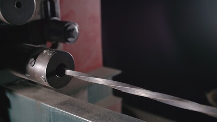 Forge workshop on table. Metal pipe craft electric twist wrought iron machine. Blacksmith makes...