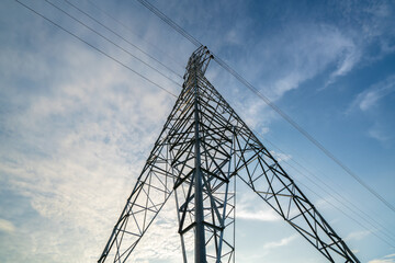 Electricity transmission power lines (High voltage tower) high-voltage lines. Transmission of electricity by means of supports through agricultural areas sunny day with landscape and sunset