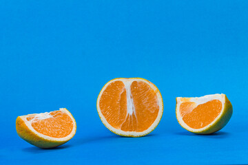 orange fruit on blue background in three parts