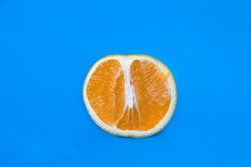 halved orange fruit on blue background