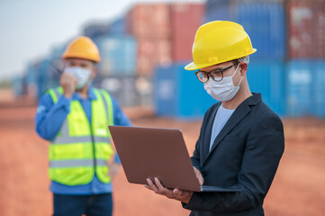 Engineers managers or businessmen work together with Foman controlling notebooks and radio Walkie-Talkie Wear a safety helmet and mask on face to prevent the spread of Coronavirus container background
