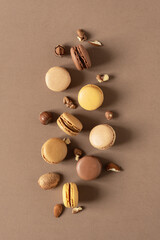 Nut macaroons dessert on brown background top view.