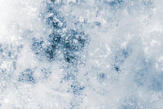 Ice texture background. Textured, blue tone, the cold, frosty surface of ice block on black background.