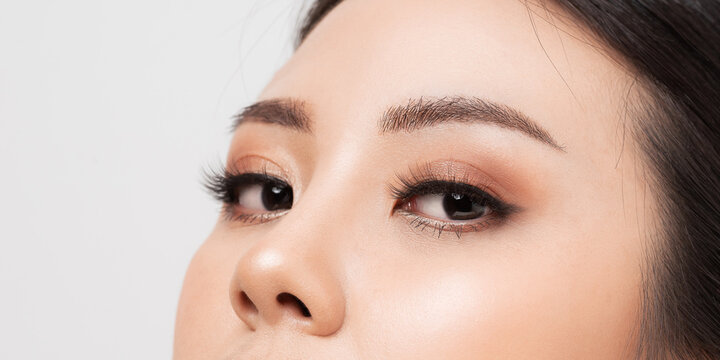 Closeup  Eye with Extreme Long False Eyelashes. Eyelash Extensions. Makeup, Cosmetics, Close up macro eye woman. Closeup face asian woman perfect skin.