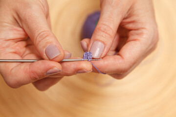 Detail of the hands crocheting