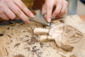carpenter&rsquo;s hands hold a chisel when processing wood