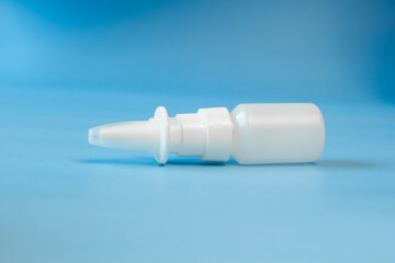 Plastic container for nose and eye drops, bottle. isolated on blue background. Place for an inscription. Copyspace