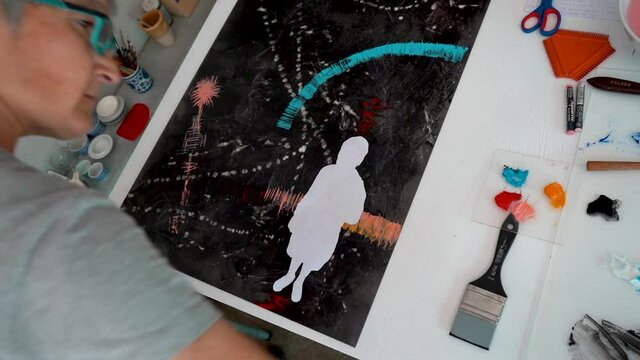 An artists painting a canvas 