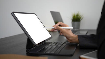 Close up view of businesswoman hands holding stylus pen pointing on empty screen of computer tablet.
