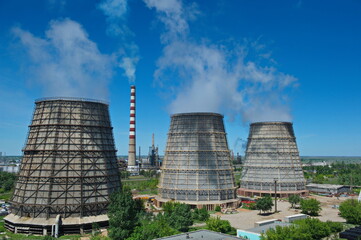 Pavlodar, Kazakhstan - 05.29.2015 : Cooling towers and pipes of various compartments of a large thermal power plant