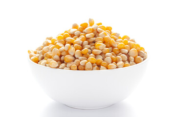 Close up organic yellow corn seed or maize (Zea mays) inside a white ceramic bowl