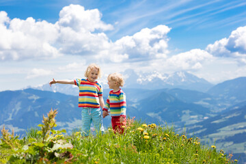 Children hiking in Alps mountains. Kids outdoor.