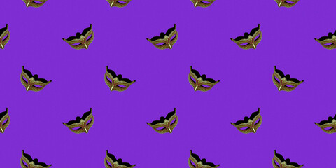 Classic Venetian theatrical mask isolated on a purple background. Seamless texture of a repeating pattern. Wallpaper design concept.