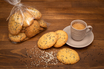 coffee with sesame cookies on a wooden table. View from above. Food concept.