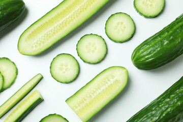Flat lay with ripe cucumbers on white background